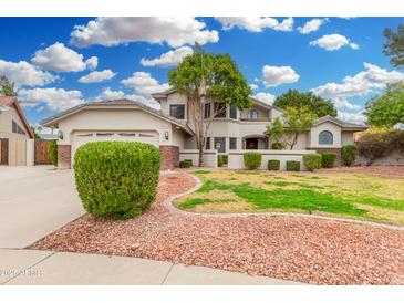 Charming two-story home with a lush, well-manicured front yard and a brick-accented facade at 19333 N 68Th Ave, Glendale, AZ 85308