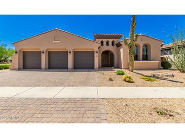 Charming single-story home featuring a three-car garage and desert landscaping at 2011 W Calle De Las Estrella --, Phoenix, AZ 85085