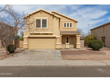 Charming two-story home with tan stucco, well-maintained landscaping, and a welcoming front entrance at 2558 W Jasper Ave, Apache Junction, AZ 85120