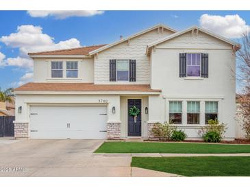 Charming two-story home with a well-manicured lawn, two car garage, and inviting front entrance at 3760 E Cotton Ct, Gilbert, AZ 85234