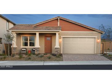 Charming single-story home featuring a two-car garage and a cozy front porch with stylish stone accents at 44323 N 43Rd Dr, Phoenix, AZ 85087