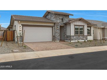 Charming home featuring a brick driveway, stone accents, and a two-car garage at 44717 N 44Th Dr, Phoenix, AZ 85087