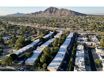 Stunning aerial view of the apartment complex with scenic mountain backdrop at 6125 E Indian School Rd # 216, Scottsdale, AZ 85251