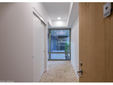 Bright hallway with travertine floors leads to a tranquil outdoor space at 7121 E Rancho Vista Dr # 5011, Scottsdale, AZ 85251