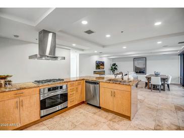 Bright kitchen featuring granite countertops, stainless steel appliances, and modern finishes in an open floor plan at 7121 E Rancho Vista Dr # 5011, Scottsdale, AZ 85251