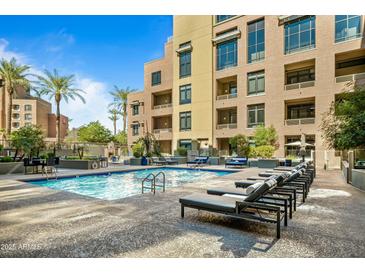 A beautiful outdoor pool with lounge chairs and tables is available at this property at 7301 E 3Rd Ave # 108, Scottsdale, AZ 85251