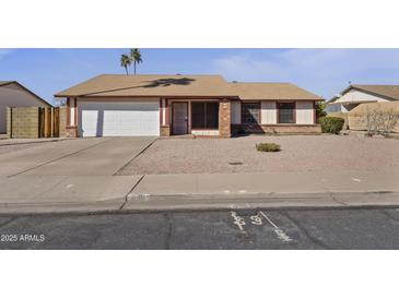 Charming single-story home featuring a two-car garage and low-maintenance gravel landscaping at 840 E Hackamore St, Mesa, AZ 85203