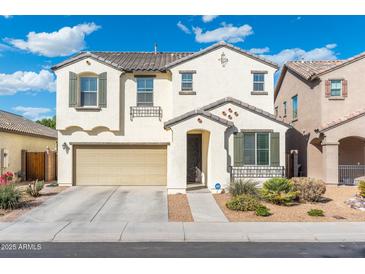 Charming two-story home with neutral stucco, tile roof, and a well-kept front yard at 12038 W Briles Rd, Peoria, AZ 85383