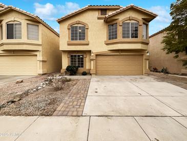 Inviting two-story home with a two-car garage and well-maintained landscaping at 1405 E Cathedral Rock Dr, Phoenix, AZ 85048