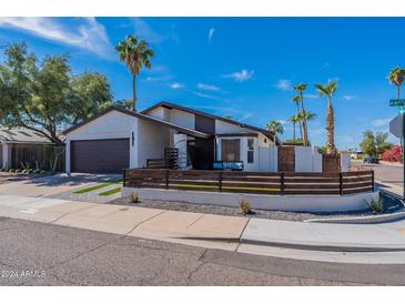 Charming single-story home with a modern fence and a well-manicured front yard, perfect for curb appeal at 1830 N 87Th Ter, Scottsdale, AZ 85257