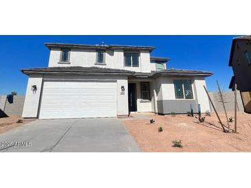 Charming two-story home featuring a spacious two car garage and desert landscaping at 18344 W Monte Lindo Ln, Surprise, AZ 85387