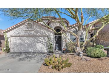 Charming single-story home showcasing desert landscaping and a cozy front entrance, near a two car garage at 1918 E Williams Dr, Phoenix, AZ 85024