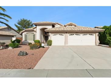 Charming single-story home with well-manicured landscaping and a spacious three-car garage at 19927 N 108Th Ln, Sun City, AZ 85373