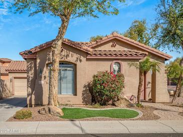 Charming single-story home with well-manicured landscaping and a tile roof in a residential neighborhood at 2722 E Wesson Dr, Chandler, AZ 85286