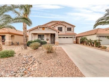 Charming two-story home with desert landscaping, palm tree, and well-maintained front yard at 38572 N Jessica Ln, San Tan Valley, AZ 85140