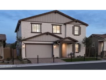 Charming two-story home featuring neutral paint, a two-car garage, a covered porch, and well-kept landscaping at 44327 N 43Rd Dr, Phoenix, AZ 85087