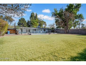 Expansive backyard features a well-maintained lawn and sparkling pool, ideal for outdoor enjoyment at 6524 N 13Th St, Phoenix, AZ 85014