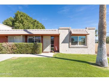 Charming single-story home with well-maintained lawn and mature landscaping at 8355 E Thomas Rd, Scottsdale, AZ 85251