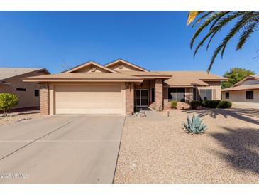 Charming single-story home with a two-car garage and low-maintenance desert landscaping at 14430 W White Rock Dr, Sun City West, AZ 85375