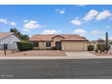 Charming single-story home featuring a tile roof, desert landscaping, and an attached two-car garage at 1651 E Kielly Ln, Casa Grande, AZ 85122