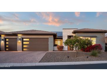 Beautiful single-story home featuring a two-car garage and desert landscaping at 18024 E Wolf Tree Ln, Rio Verde, AZ 85263