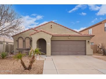 Charming single-story home featuring a two-car garage and a well-maintained front yard at 2021 S 84Th Ave, Tolleson, AZ 85353