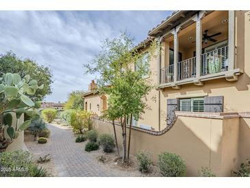 Charming two-story home with a balcony and desert landscaping at 20704 N 90Th Pl # 1065, Scottsdale, AZ 85255