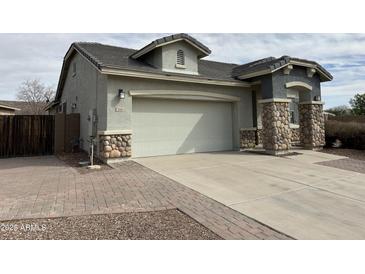 Charming single-story home with a two car garage and stone veneer accents at 2344 E Alida Trl, Casa Grande, AZ 85194