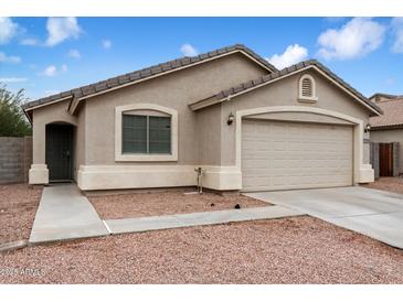 Charming single-story home with desert landscaping and attached two-car garage at 24118 W Desert Bloom St, Buckeye, AZ 85326