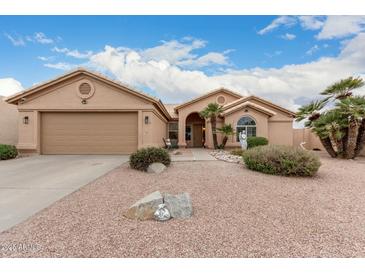 Single-story home featuring a two car garage and a desert landscaped front yard at 26681 S Howard Dr, Sun Lakes, AZ 85248