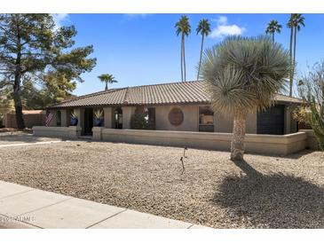 Charming single-story home featuring a tile roof, desert landscaping, and a neutral-tone facade at 301 E Carol Ann Way, Phoenix, AZ 85022