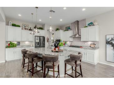 Spacious kitchen boasts a large island with seating, granite counters, and stainless steel appliances at 3932 E Torrey Pines Ln, Chandler, AZ 85249