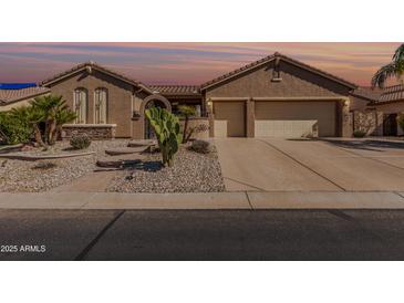 Well-maintained single-story home with desert landscaping, multi-car garage, and a neutral color scheme at 5161 N Scottsdale Rd, Eloy, AZ 85131