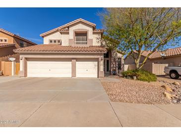 Exterior view of home featuring a three car garage, desert landscaping, and tile roof at 5356 W Jupiter Way, Chandler, AZ 85226