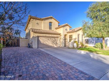 Charming two-story home with a spacious driveway and manicured front yard, showcasing curb appeal at 7010 S San Jacinto Ct, Gilbert, AZ 85298