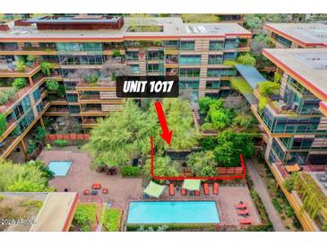 Exterior view of Unit 1017 with private pool area, greenery, and lounge seating at 7151 E Rancho Vista Dr # 1017, Scottsdale, AZ 85251