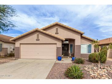 Charming single-story home featuring a two-car garage and low maintenance desert landscaping at 8204 W Tonto Ln, Peoria, AZ 85382