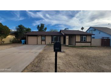 Charming single-story home featuring a well-maintained front yard and a cozy, inviting entrance at 8815 W Columbus Ave, Phoenix, AZ 85037