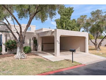 Charming single-story home with a covered parking area, desert landscaping, and mature trees at 934 E Cochise Dr, Phoenix, AZ 85020