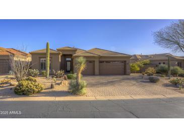 Inviting single-story home with a paver driveway and desert landscaping, including cacti and mature trees at 9785 E Preserve Way, Scottsdale, AZ 85262