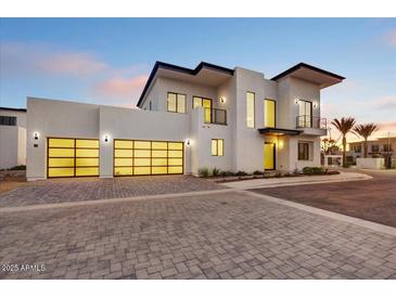 Modern two-story home featuring an attached two-car garage and landscaped front yard at 100 W Northern Ave # 13, Phoenix, AZ 85021