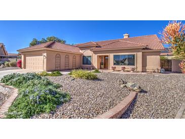Inviting single-story home featuring desert landscaping, a two-car garage, and beautiful curb appeal at 13214 S 39Th St, Phoenix, AZ 85044