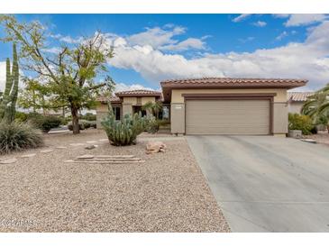 Charming desert home featuring low-maintenance landscape and a neutral color palette at 15022 W Cooperstown Way, Surprise, AZ 85374