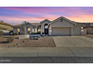 Charming single-story home with a landscaped front yard and a spacious two-car garage at 1635 E Silverwood Dr, Phoenix, AZ 85048
