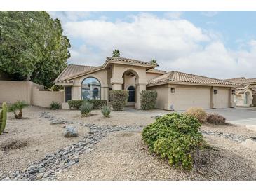 Charming single-story home features a landscaped front yard and a three-car garage at 1835 E Brookwood Ct, Phoenix, AZ 85048