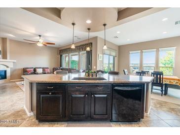 Open-concept kitchen with granite countertops and stainless steel appliances at 29412 N 128Th Ln, Peoria, AZ 85383