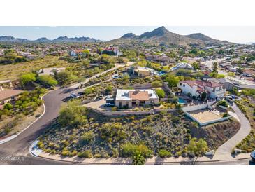 Stunning aerial view of a desert home with a meticulously landscaped yard and mountain backdrop at 3101 E Acoma Dr, Phoenix, AZ 85032
