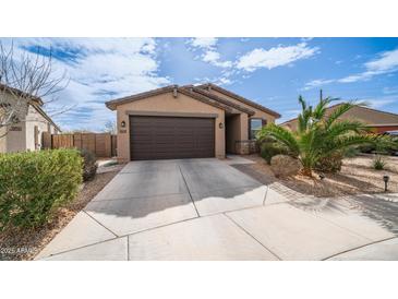 Charming single-Gathering home featuring a well-maintained front yard and attached two-car garage at 40433 W Hensley Way, Maricopa, AZ 85138