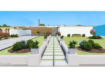 Landscaped front yard featuring a modern walkway and a covered porch with outdoor seating at 1048 E 2Nd Pl, Mesa, AZ 85203