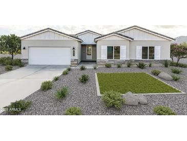 Charming single-story home with a stone accent, two-car garage, and low maintenance xeriscape front yard at 11218 E Crescent Ave, Mesa, AZ 85208